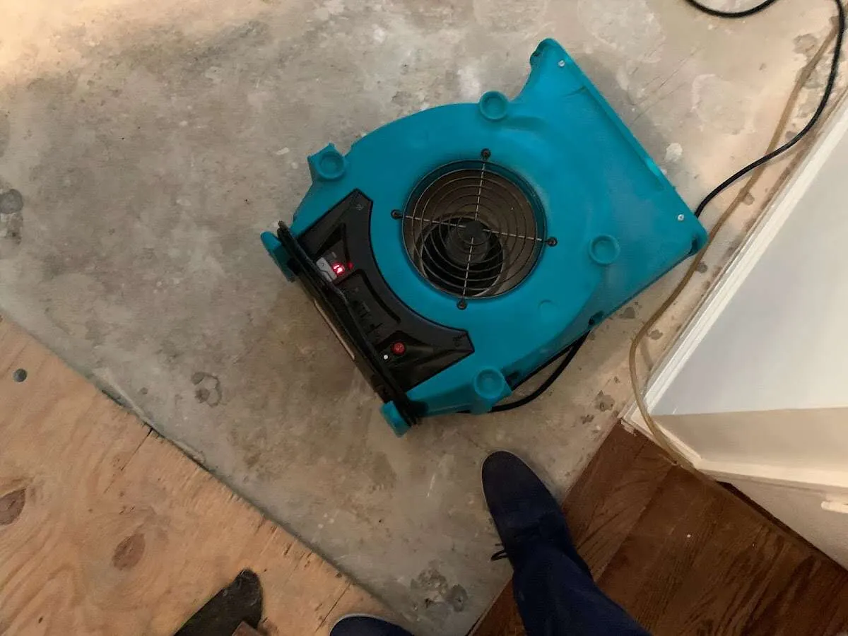 Air mover drying subfloor during Commercial Water Damage Restoration in Opa-locka
